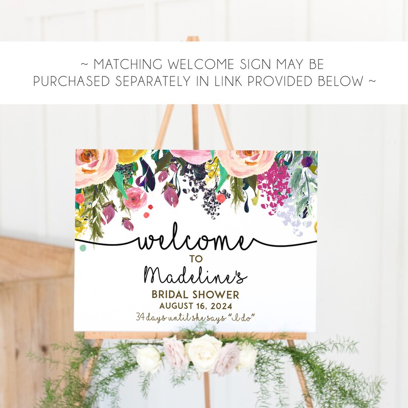 May include: A white welcome sign with a floral border and the text "welcome to Madeline's Bridal Shower August 16, 2024 34 days until she says "I do""