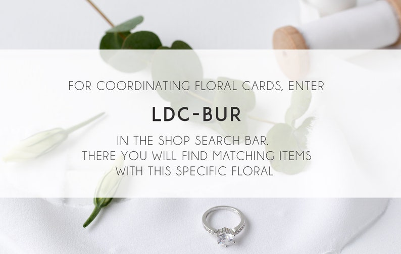 May include: White background with a silver ring, green leaves, and white flowers. Text reads: "FOR COORDINATING FLORAL CARDS, ENTER LDC-BUR IN THE SHOP SEARCH BAR. THERE YOU WILL FIND MATCHING ITEMS WITH THIS SPECIFIC FLORAL"