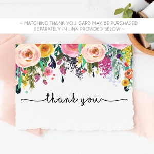 May include: A white thank you card with a floral border in shades of pink, yellow, purple, and green. The text "thank you" is written in black cursive script.