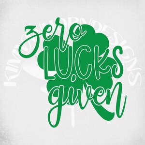 May include: A green graphic with the words "zero lucks given" in a whimsical font, set against a white background. A green shamrock shape is behind the text. The design is suitable for St. Patrick's Day.