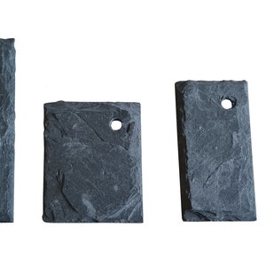 May include: Four black slate rectangular tags with a hole in the top. The tags are different sizes.