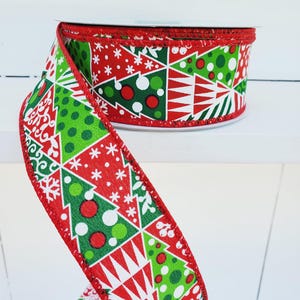 May include: Red and green Christmas ribbon with a patchwork design of Christmas trees, snowflakes, and polka dots. The ribbon has a red edge.