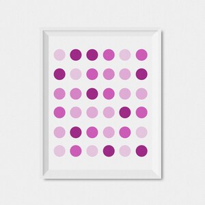 May include: A framed print with a geometric pattern of pink and purple circles.