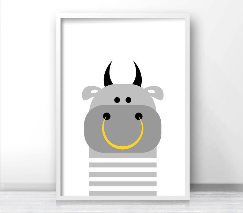 May include: A gray bull with black horns and a yellow smiley face. The bull is wearing a gray and white striped shirt.