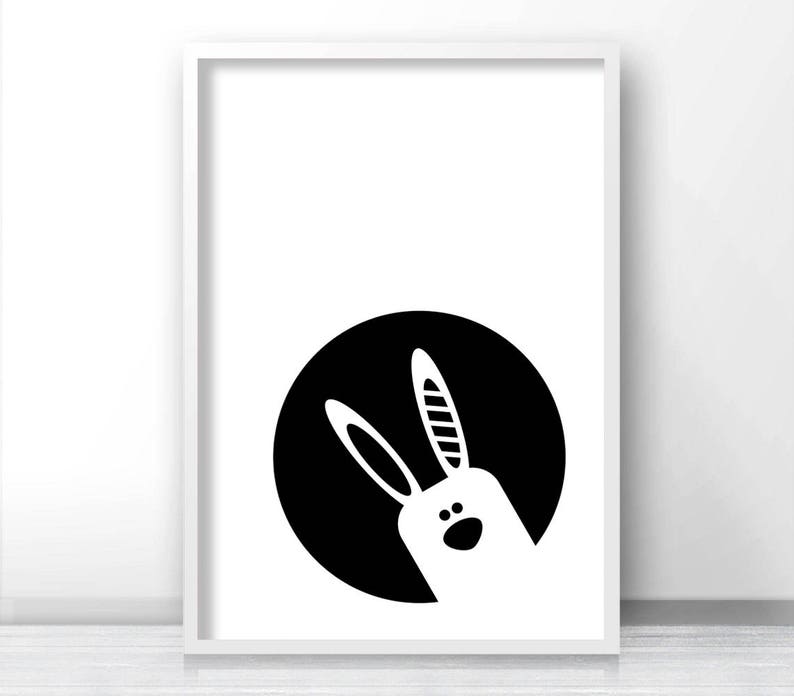 May include: Black and white illustration of a bunny rabbit's face peeking out from a circle.