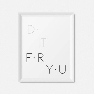 May include: A white framed print with the text "D. IT F. R Y. U" in black and gray lettering.