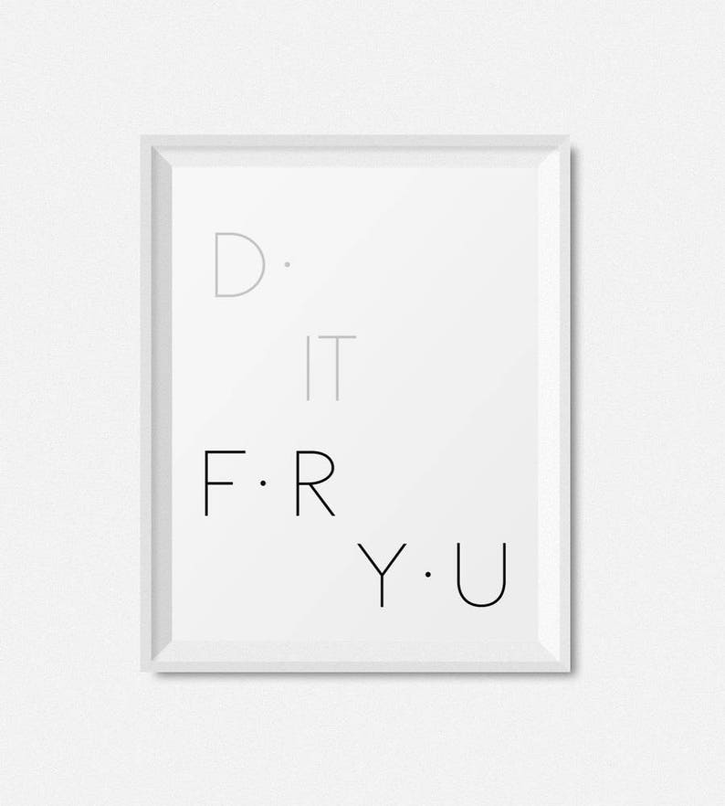May include: A white framed print with the text "D. IT F. R Y. U" in black and gray lettering.