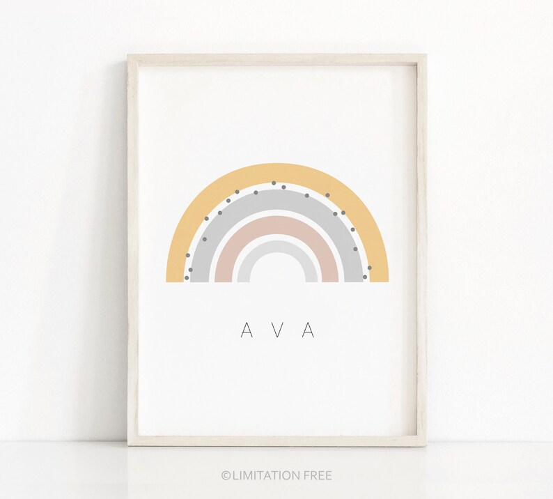 May include: A framed print with a rainbow design in yellow, pink, and gray with black dots. The name "AVA" is printed below the rainbow.
