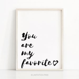 May include: A white framed print with black text that reads "You are my favorite" with a small heart symbol.