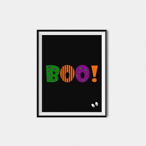 May include: A black framed print with the word "BOO!" in colorful letters. The letters are green, orange, purple, and orange. There are two white eyes on the bottom right corner of the print.