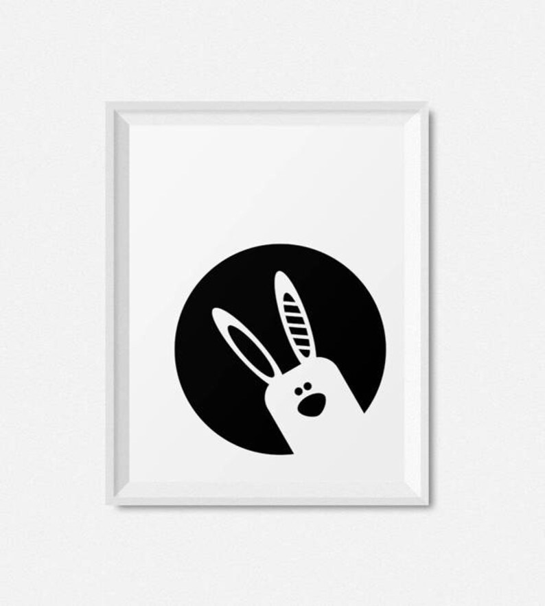 May include: Black and white illustration of a rabbit's head peeking out from a black circle.