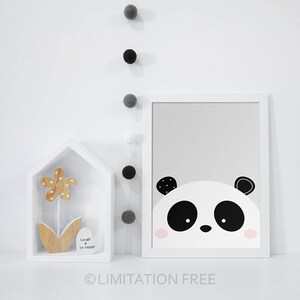 May include: A black and white panda bear face illustration with pink cheeks on a grey background. The illustration is framed in a white frame.