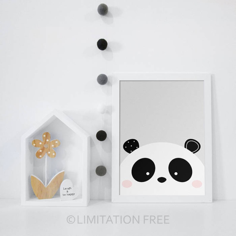 May include: A black and white panda bear face illustration with pink cheeks on a grey background. The illustration is framed in a white frame.