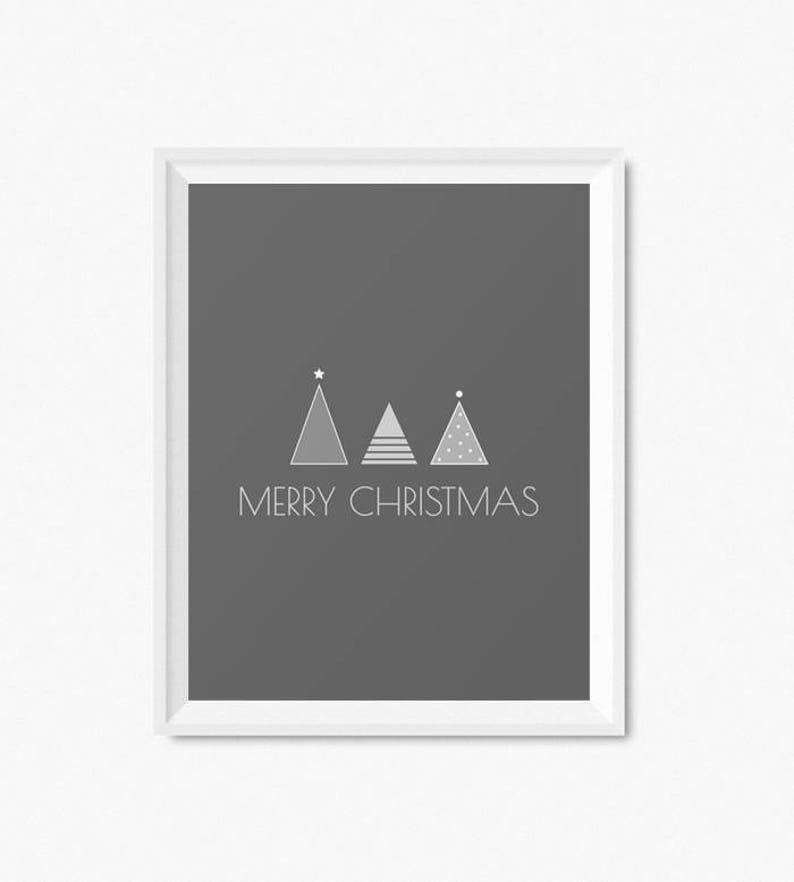 May include: A gray framed print with three stylized white Christmas trees and the text "Merry Christmas" on a dark gray background.