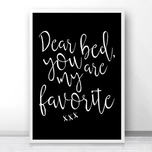 May include: A framed black and white print with the text "Dear bed, you are my favorite" in elegant cursive script. The print has a white border and is suitable for bedroom decor.