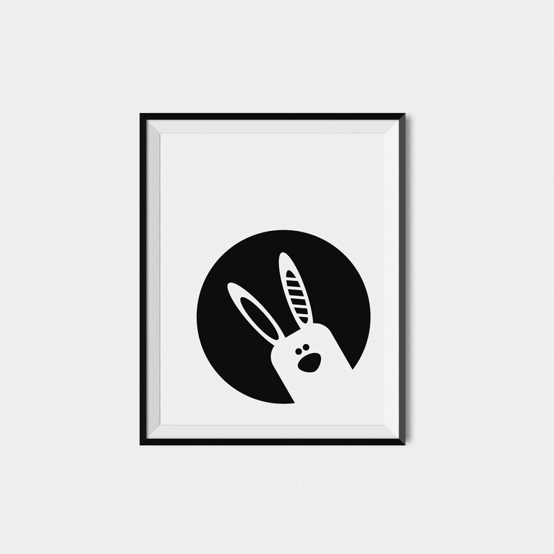 May include: Black and white illustration of a rabbit's head peeking out from a circle.