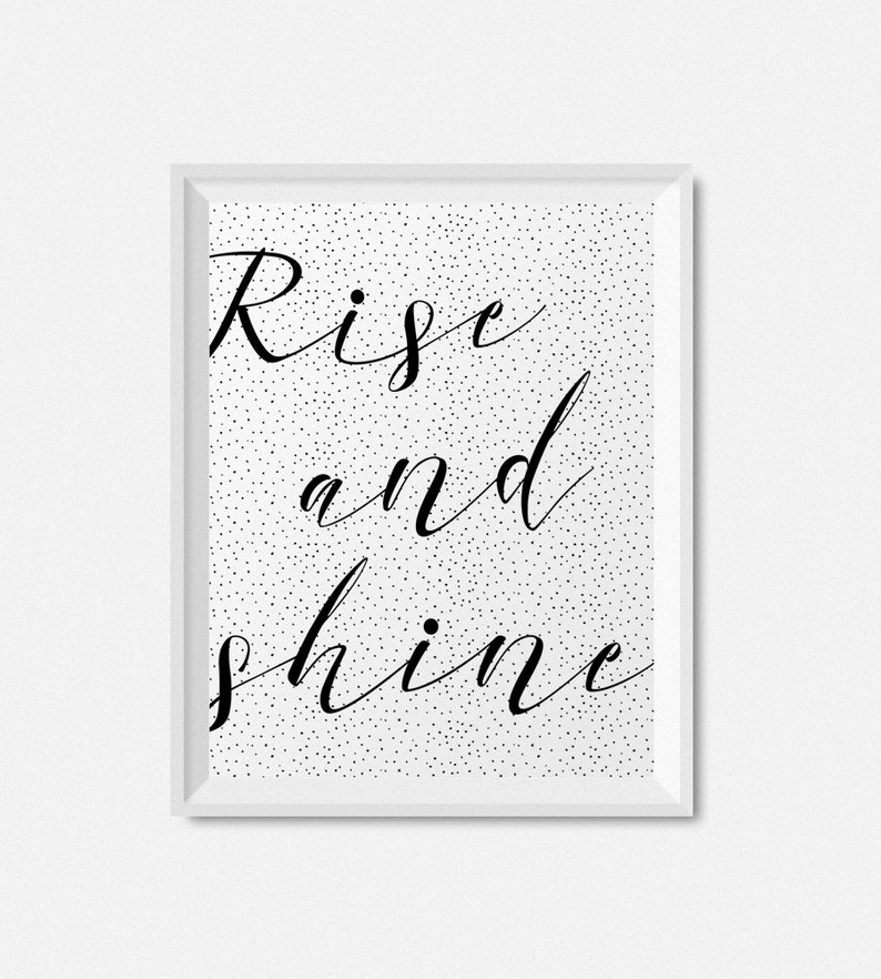 May include: Black and white printable wall art with a white background and black polka dots. The text "Rise and shine" is written in a cursive font.