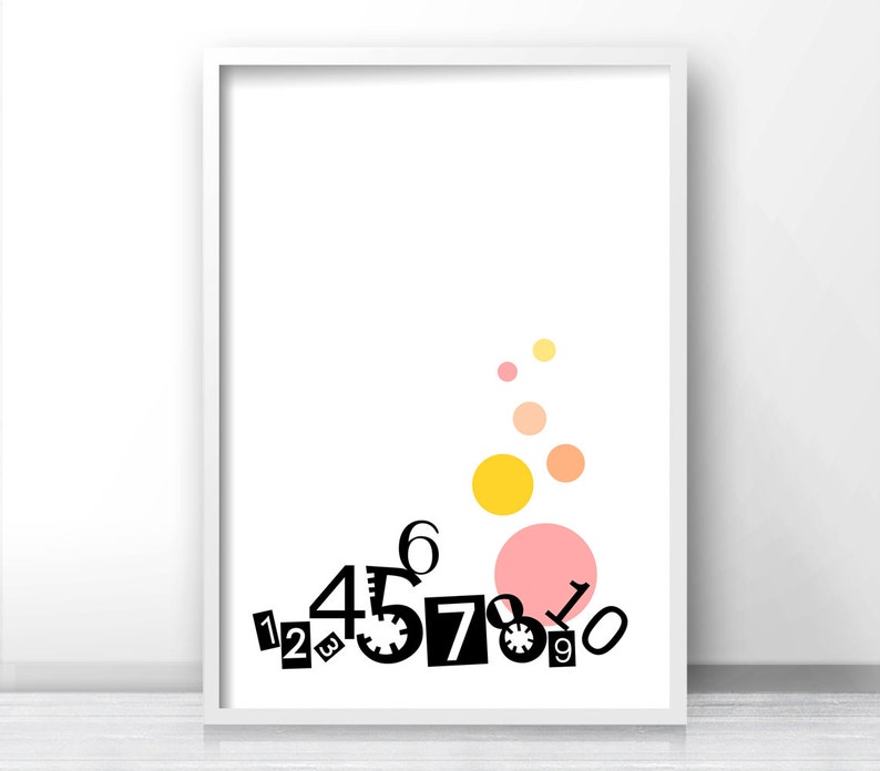 May include: A white framed print with black numbers 1 through 9 scattered across the bottom. The numbers are in a playful, jumbled arrangement. Above the numbers are five colorful circles in shades of pink, orange, and yellow.