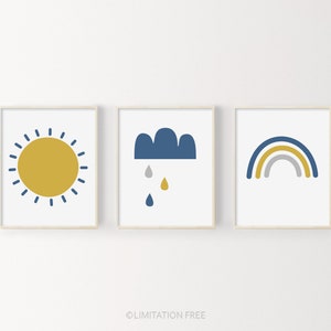 May include: Three framed prints with a minimalist design. The first print features a yellow sun with blue rays. The second print features a blue cloud with three raindrops. The third print features a rainbow with blue, yellow, and gray stripes.