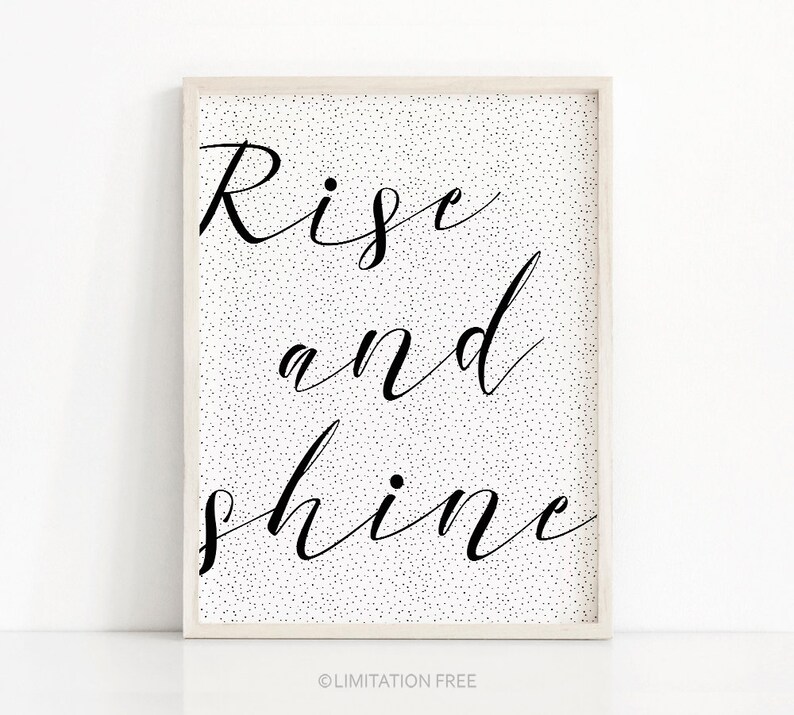 May include: Black and white printable wall art with the text "Rise and shine" on a white background with black dots.