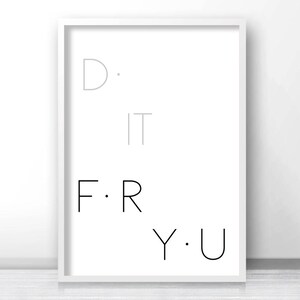 May include: A white framed print with the text "D. IT F. R Y. U" in black and gray lettering.
