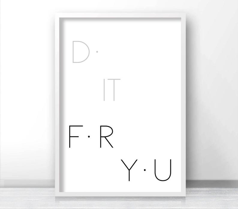 May include: A white framed print with the text "D. IT F. R Y. U" in black and gray lettering.
