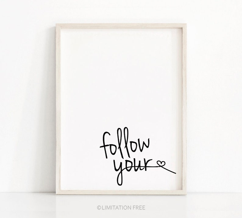 May include: A framed print with the text "follow your" and a heart drawn at the end of the word "your".