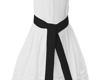May include: A white sleeveless dress featuring a black sash tied at the waist. The skirt is full, with horizontal ribbon detailing near the hem. This dress is suitable for special occasions.