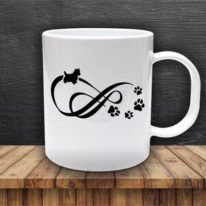 May include: White ceramic mug with a black silhouette of a dog and paw prints in an infinity symbol design.