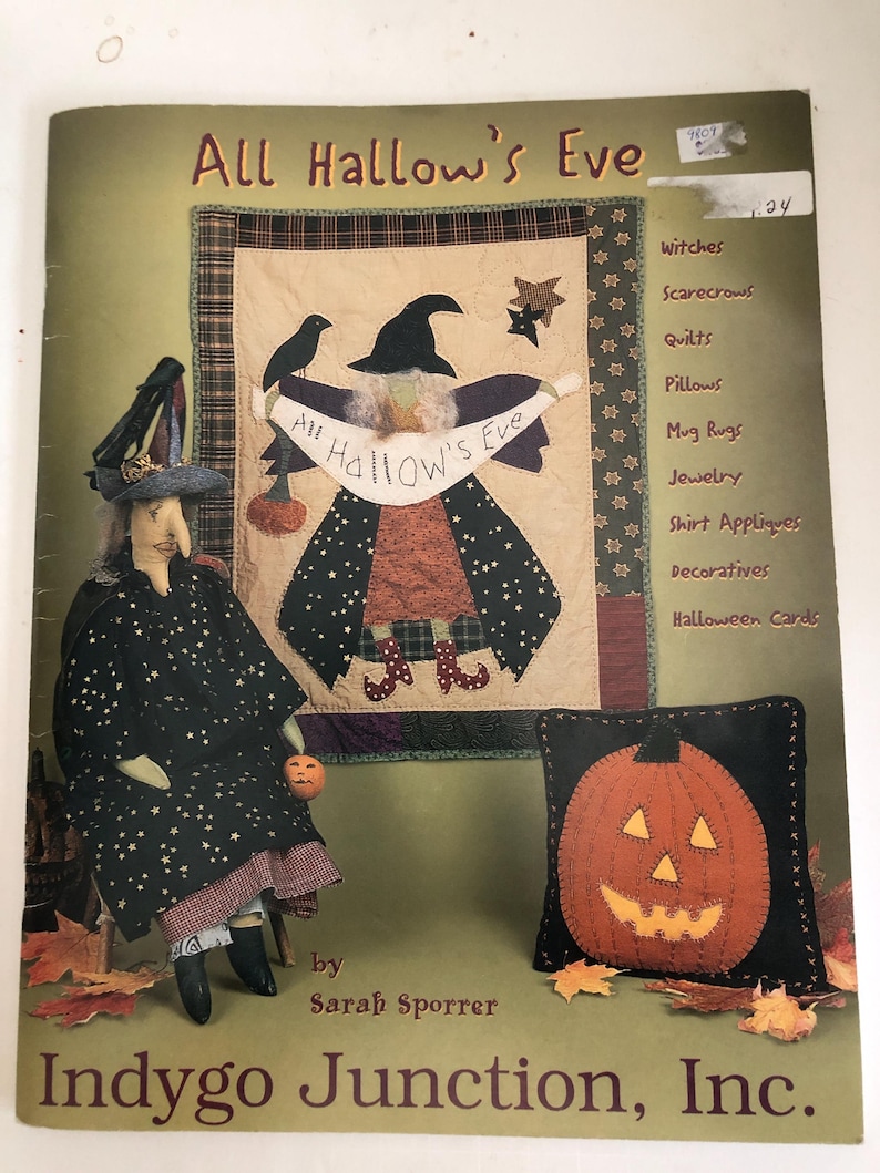 May include: A book cover titled "All Hallow's Eve" featuring a witch doll, a quilted wall hanging, and a pumpkin pillow. The cover includes a list of related items such as quilts, pillows, and jewelry. The book is by Sarah Sporrer and published by Indygo Junction, Inc.