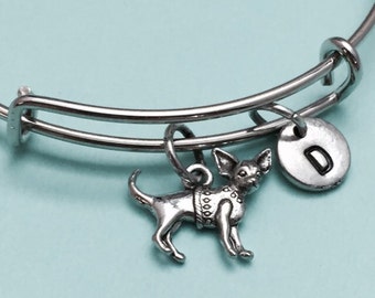 May include: Silver charm bracelet with a chihuahua charm and a letter D charm. The bracelet is expandable and has a silver finish.