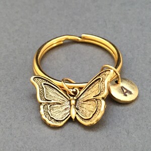 May include: Gold butterfly keychain with a gold letter 'A' charm.