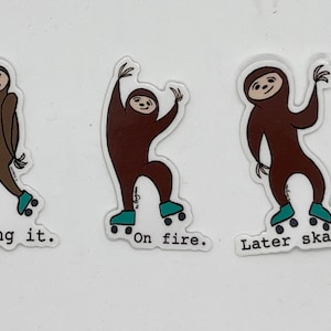 May include: Three sloth stickers on a white background. Each sloth is wearing roller skates and has a different caption. The first sloth says "Killing it." The second sloth says "On fire." The third sloth says "Later skater."