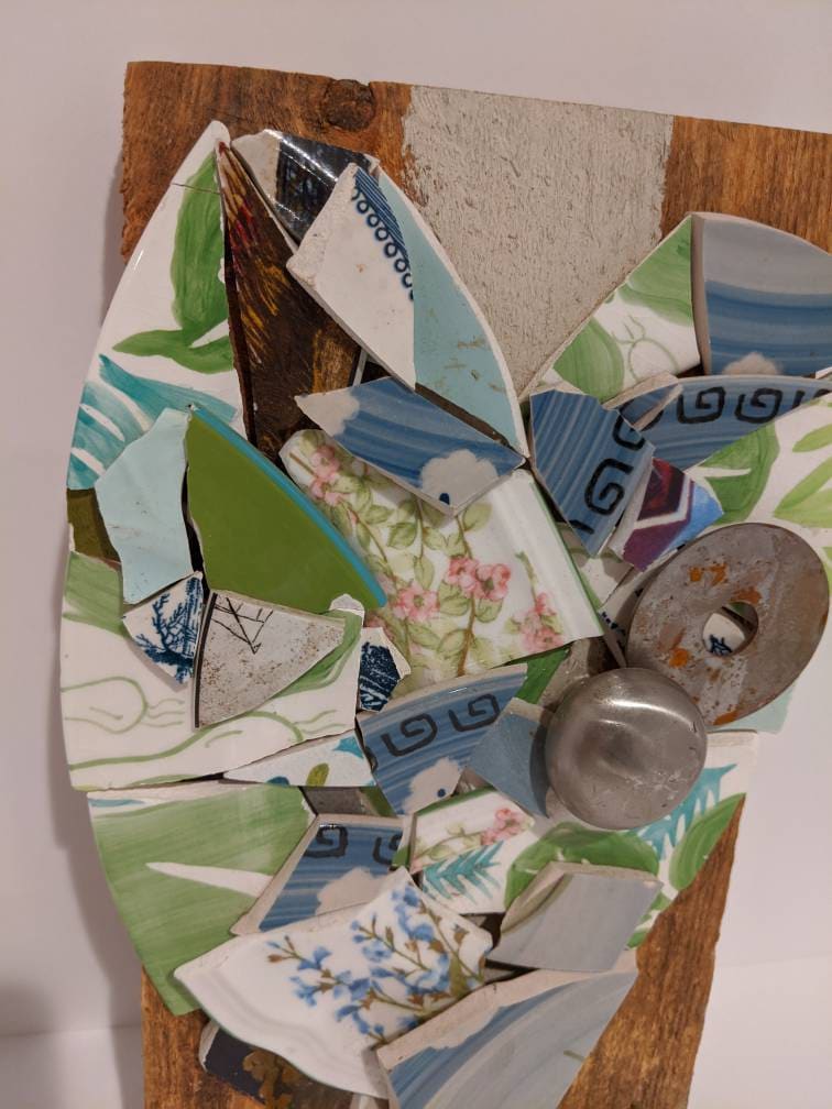This broken pottery upcycled mosaic art is made from several Etsy