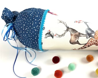 May include: A blue and white fabric cone with a blue ribbon and pom-poms. The cone is decorated with a print of animals, including a giraffe, a deer, and a puffin.