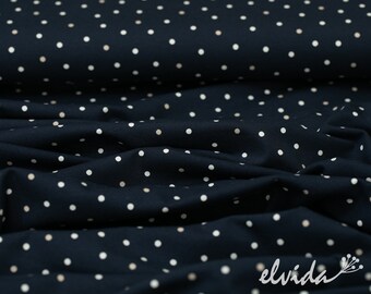 Tejido de punto con lunares beige