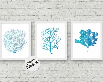May include: Three framed art prints with watercolour illustrations of coral and seaweed in shades of blue and teal. The prints are displayed against a white brick wall. The text "DIGITAL DOWNLOAD" is on a white circle.