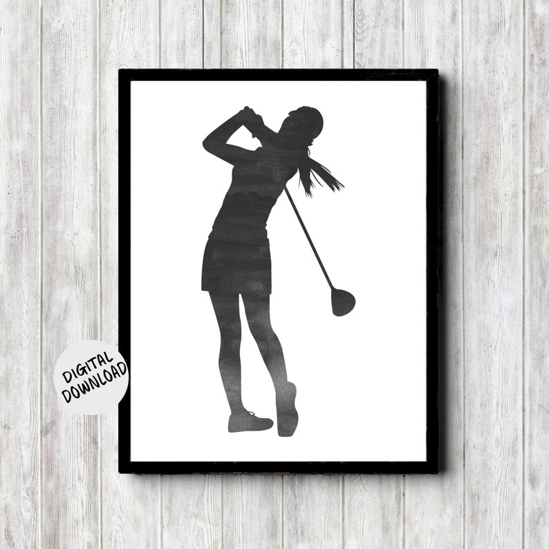 printable wall art of a female golfer silhouette in a grungy charcoal watercolor. she is standing in the position of a golfer after teeing off with the club over her shoulder