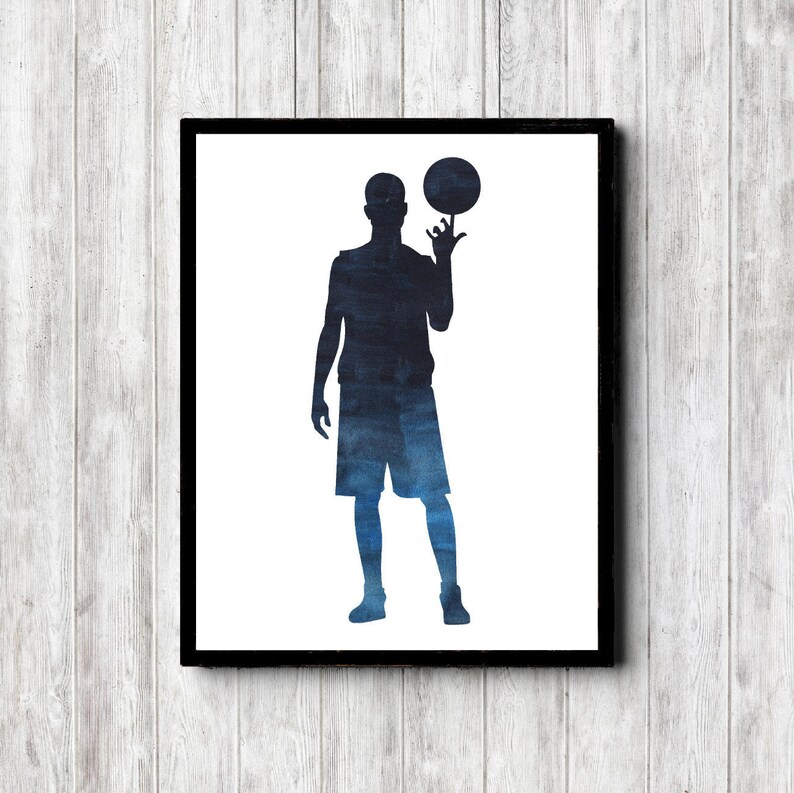 May include: A watercolor silhouette of a basketball player in blue and black, holding a basketball in their right hand.