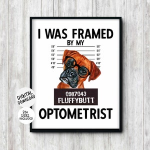 May include: A white background with a black frame around a humorous poster featuring a cartoon boxer dog wearing glasses. The poster says "I was framed by my 0987043 FLUFFYBUTT OPTOMETRIST".