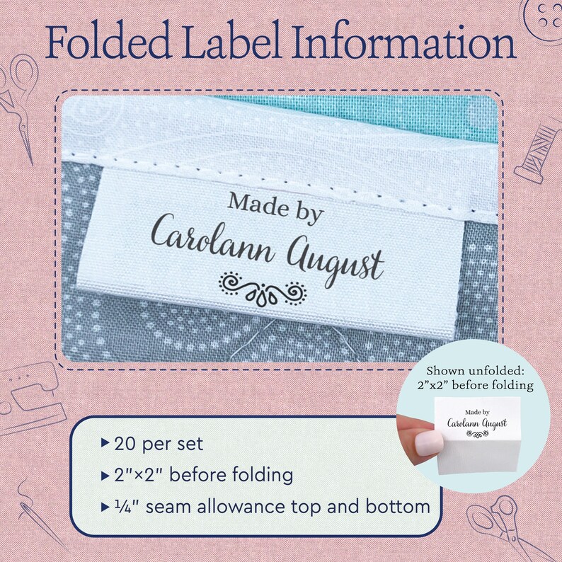 May include: A white fabric clothing label with black text reading Made by Carolann August and a decorative flourish. The label is shown folded on a blue patterned fabric. The set includes 20 labels, each measuring 2 inches by 2 inches before folding.
