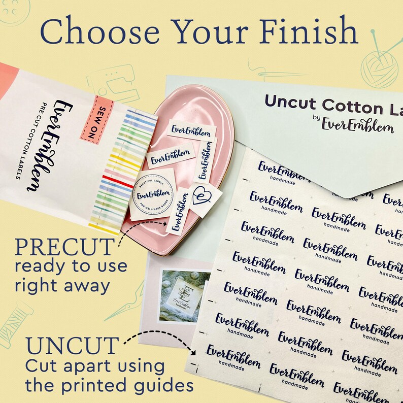 May include: A collection of EverEmblem cotton labels including a package of pre-cut sew-on labels, a pink dish containing loose labels, and a sheet of uncut cotton labels with printed guides. The text reads Choose Your Finish and Uncut Cotton Labels.