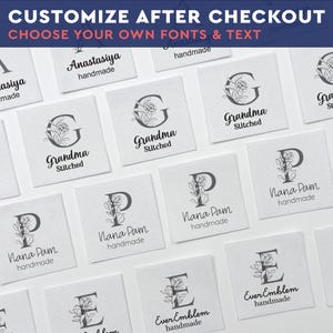 May include: A collection of square white fabric labels featuring black printed designs. Each label displays a large capital letter intertwined with floral illustrations, accompanied by custom text such as Grandma Stitched, Nana Pam handmade, or EverEmblem handmade.
