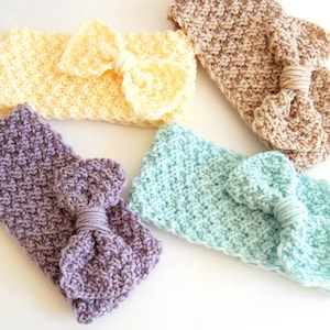 May include: Four crocheted headbands with bows in different colours: pale yellow, light brown, light purple, and light blue.