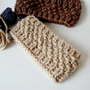 May include: Two crocheted headbands, one brown and one beige. The beige headband is made with a textured stitch.