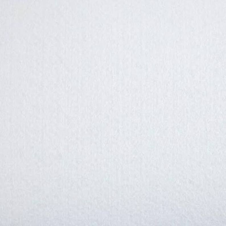 May include: A plain white background with a slightly textured surface.