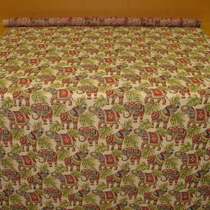 May include: A beige fabric with a repeating pattern of colorful elephants and green leaves. The elephants are decorated with red, blue, and gold accents.