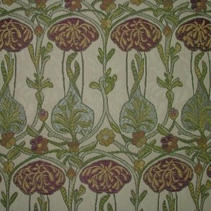May include: Close-up of a floral pattern fabric. The design features repeating motifs of stylized flowers in shades of burgundy and gold, with green leaves and stems against a cream background. The fabric has a woven texture.