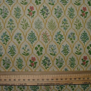 May include: Fabric featuring a repeating floral pattern with pink, blue, and green flowers. The flowers are set against a cream background with a gold trellis design. Suitable for craft projects. Measurements are in centimetres.