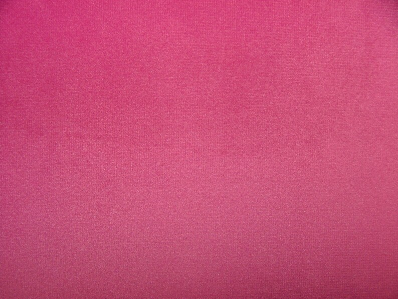 May include: A solid pink fabric with a subtle textured surface.